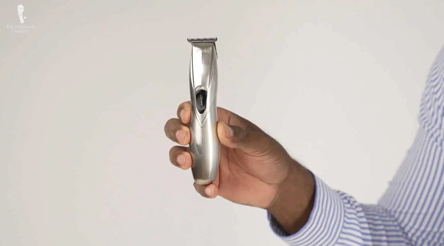A hand holding a beard trimmer