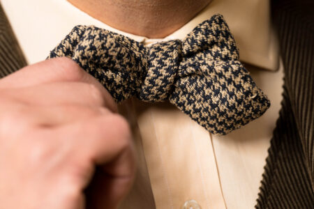 A photo of a grey and green hounds tooth bowtie