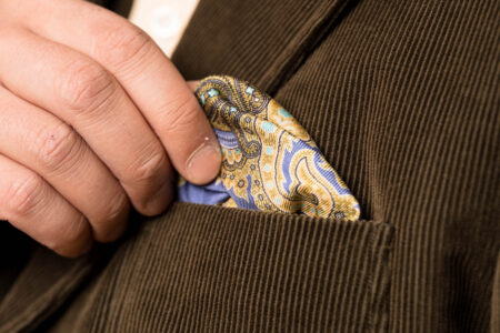 A photograph of a Violet Silk Pocket Square with Green Paisley
