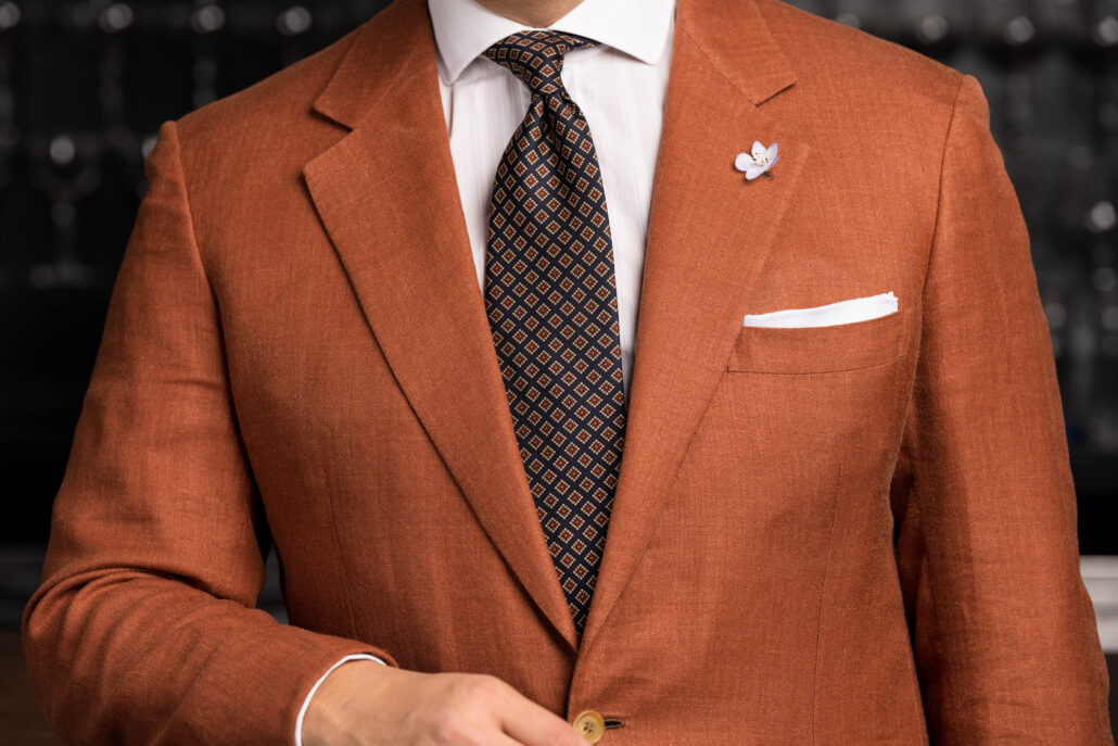 A rust orange suit with accessories 