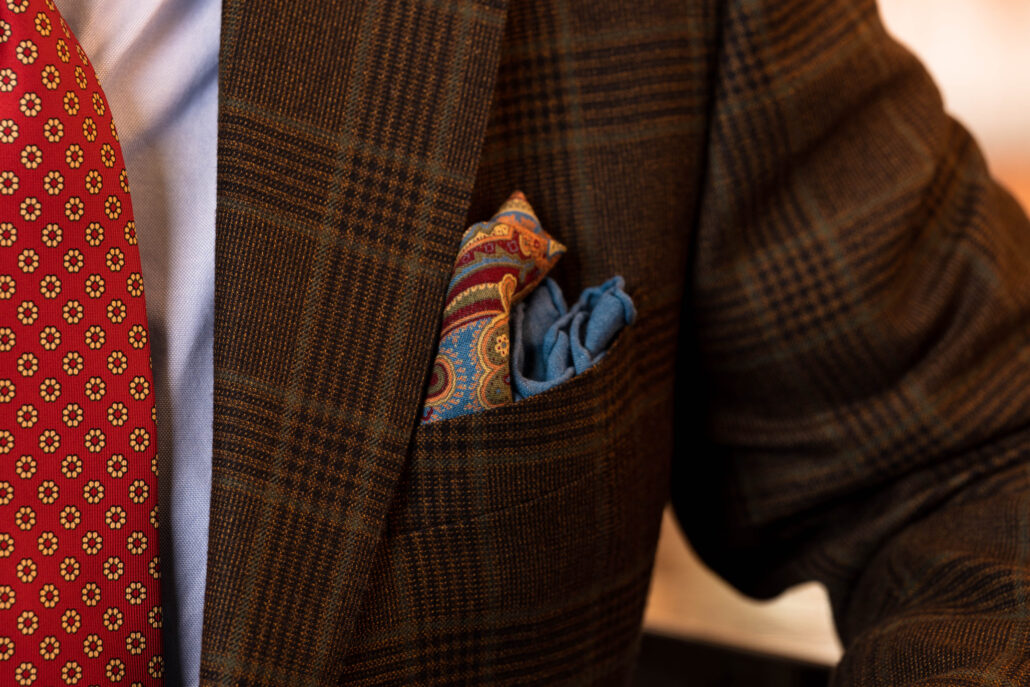 A colorful pocket square in a front jacket pocket