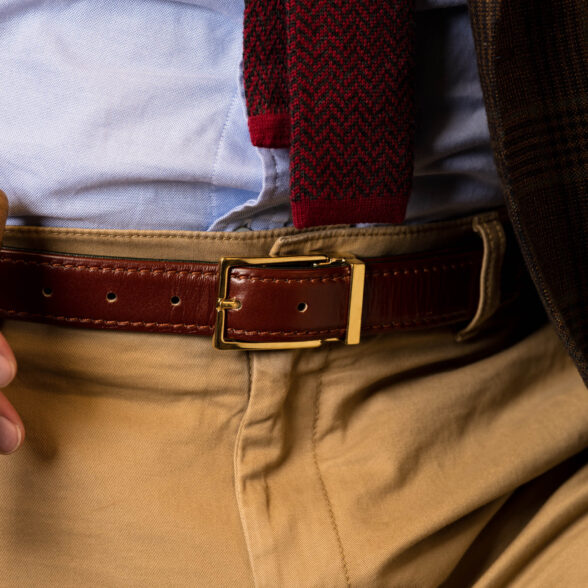 A photograph of a belt worn with tan trousers