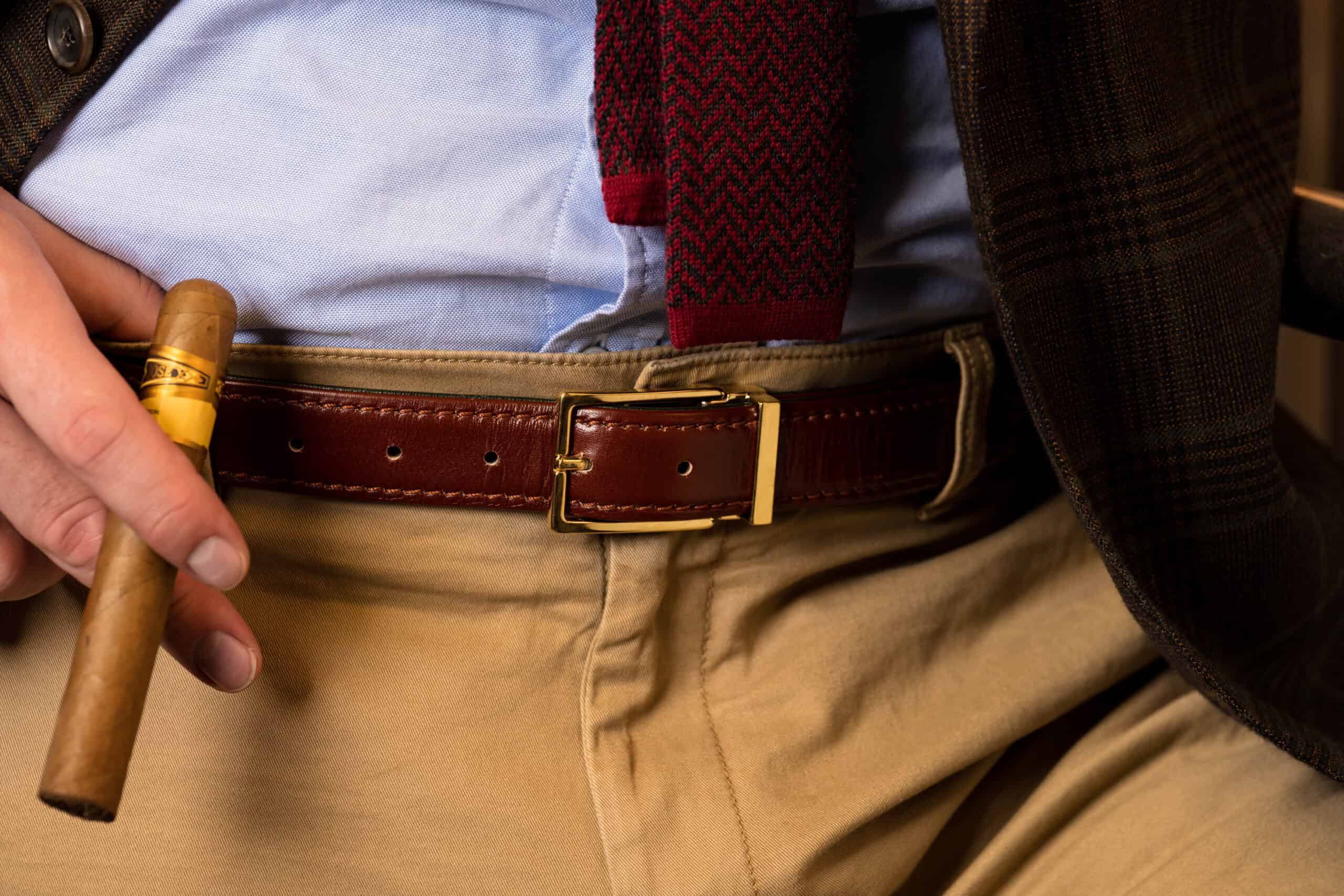 A photograph of a belt worn with tan trousers
