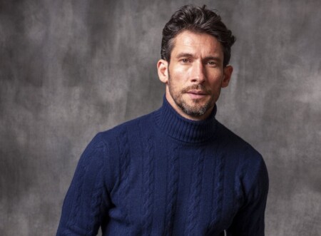 A deep blue cable knit roll neck from Pini Parma