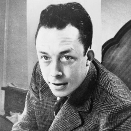 A black and white photograph of Albert Camus