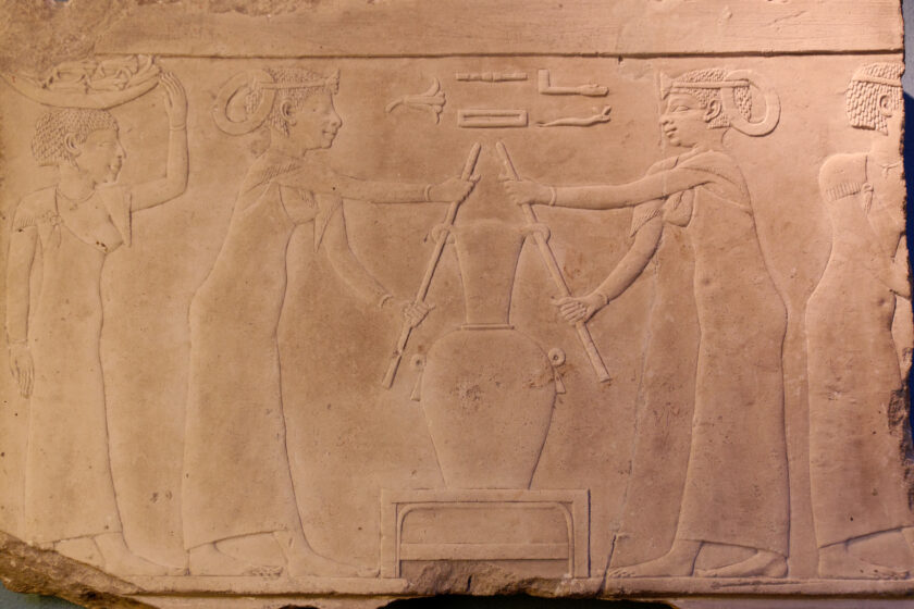 A photograph of a stone tablet depicting Egyptian women making perfume. 