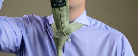 Pull the wide end up behind the tie knot