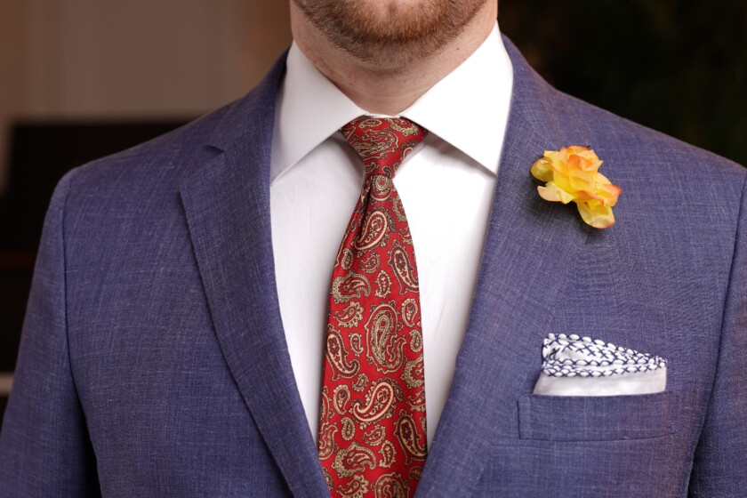 The Half Windsor Knot looks particularly elegant with a red and gold paisley tie