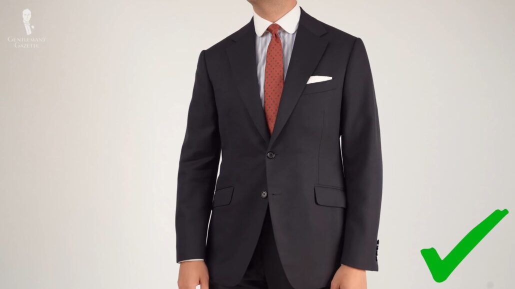 A timeless suit jacket with a medium-wide lapel and two buttons as worn by Raphael (Pictured: White Linen Pocket Square with Handrolled Edges from Fort Belvedere)