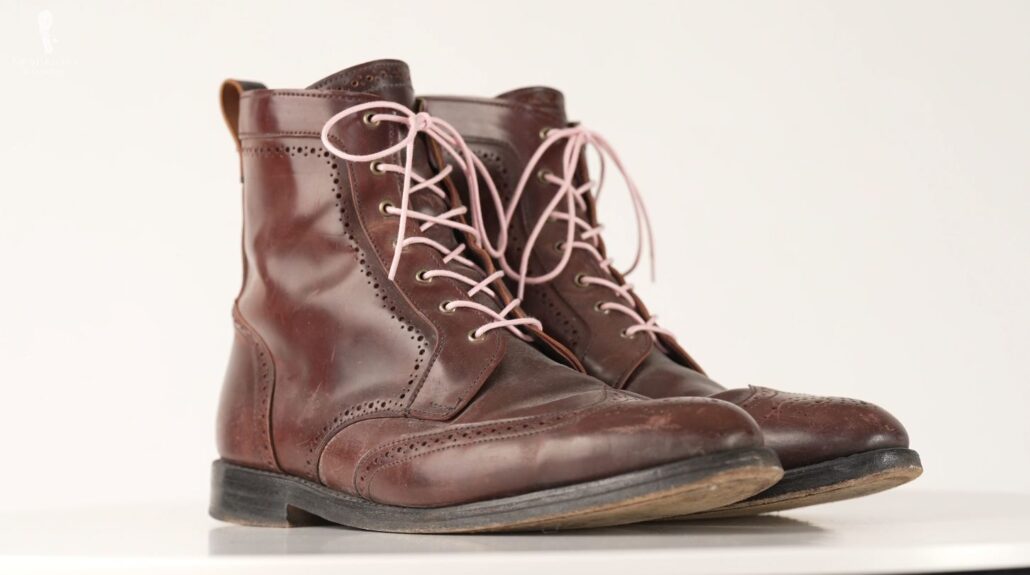 A pair of wingtip Derby boots with broguing (Pictured: Pale Pink Boot Laces Round Waxed Cotton from Fort Belvedere)