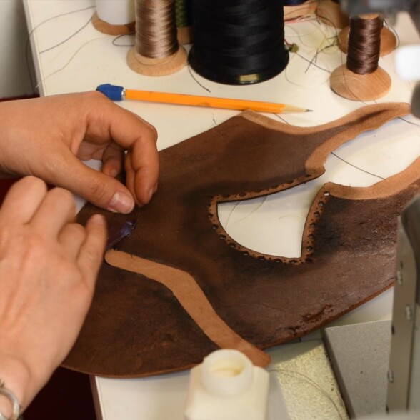 Before stitching, Amara uses glue to give the leather pieces a tight seal.
