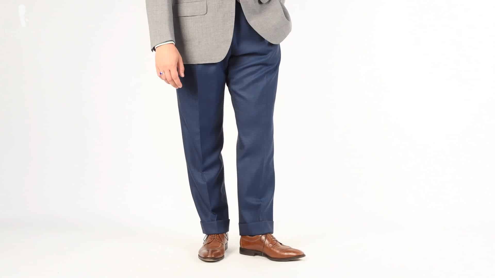 Blue pants paired with gray jacket and brown shoes