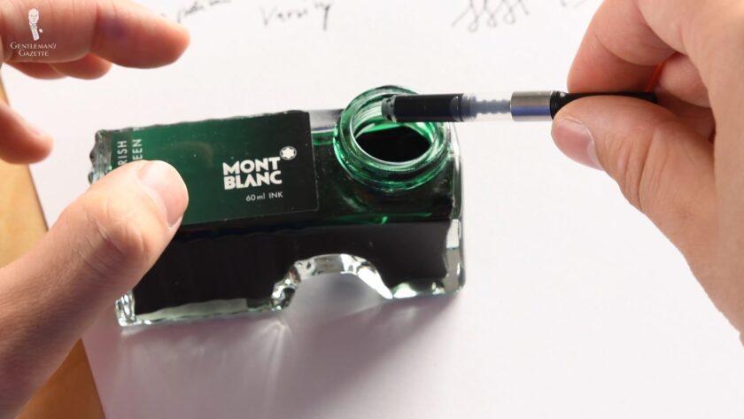 Raphael refills his fountain pen’s signature green ink
