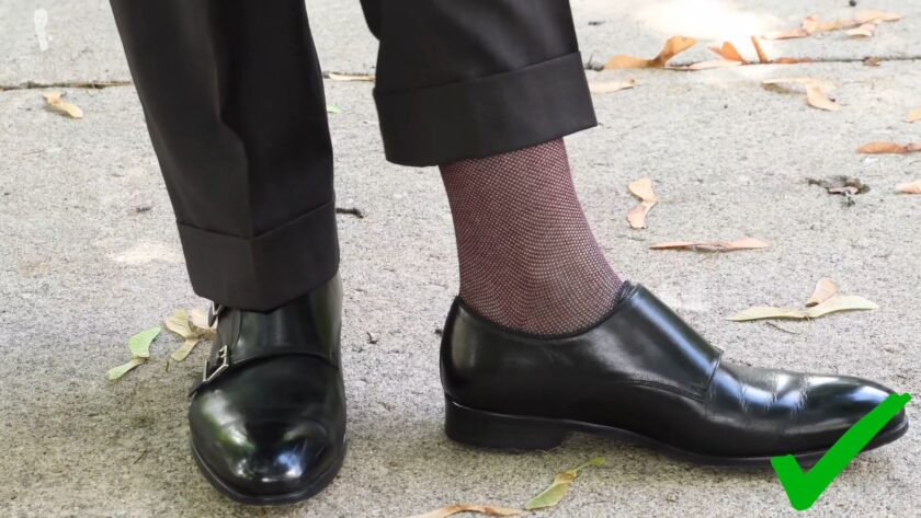 A photo of burgundy socks with black shoes. 