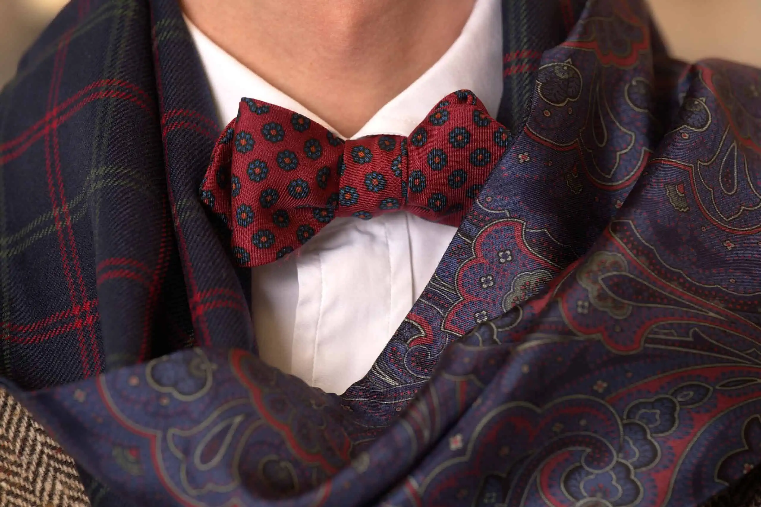 A photo of a Double Sided Scarf in Blue Silk Wool Paisley and Plaid with bow tie