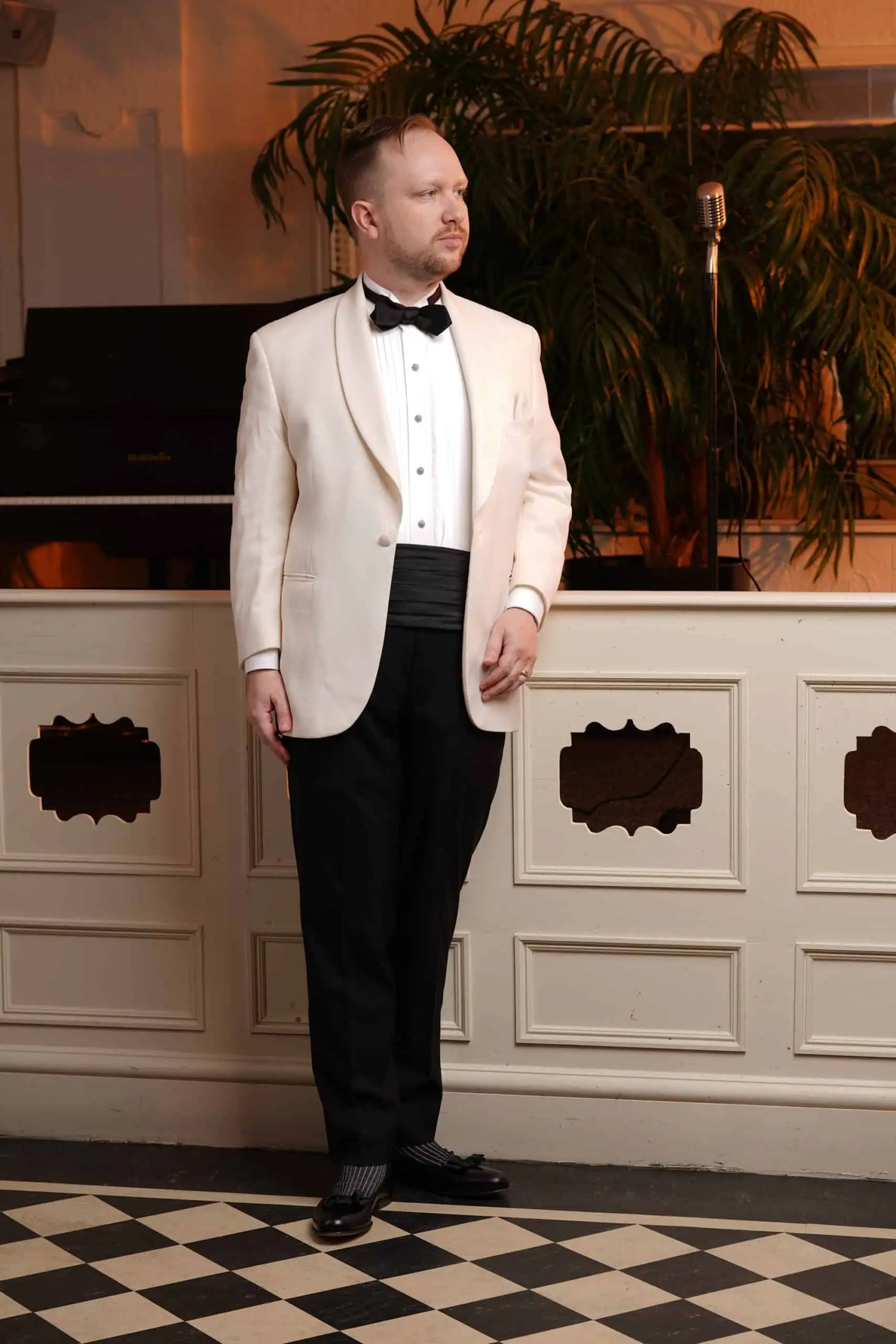 Eb wears a Black Tie ensemble with an ivory dinner jacket
