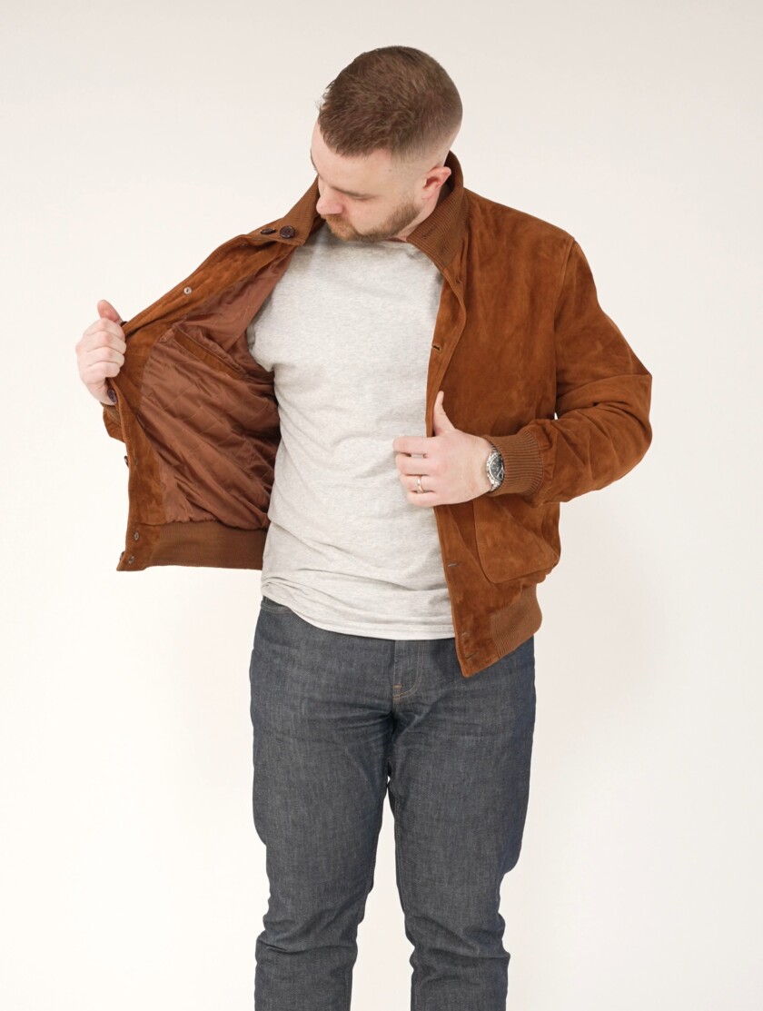 Nathan showcases how a simple tee can make a big impact under a suede bomber jacket
