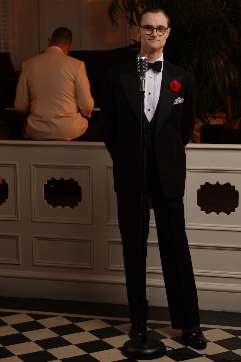 Preston Sings In Black Tie Preston stands at a microphone in Black Tie