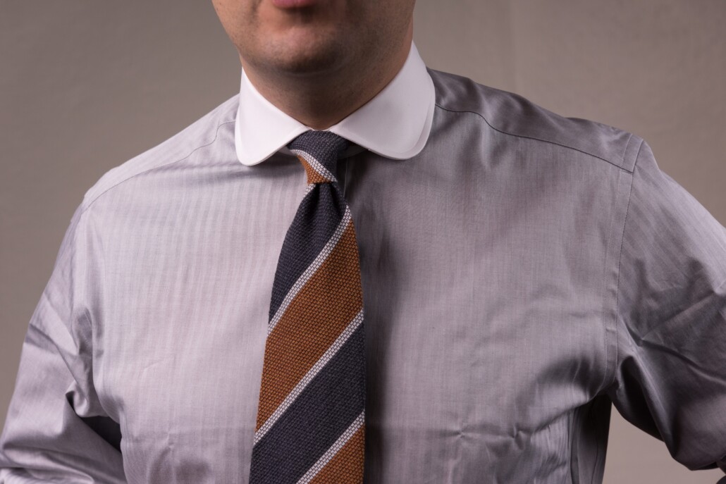 Raphael wears a particularly elegant club collar shirt with a repp stripe tie