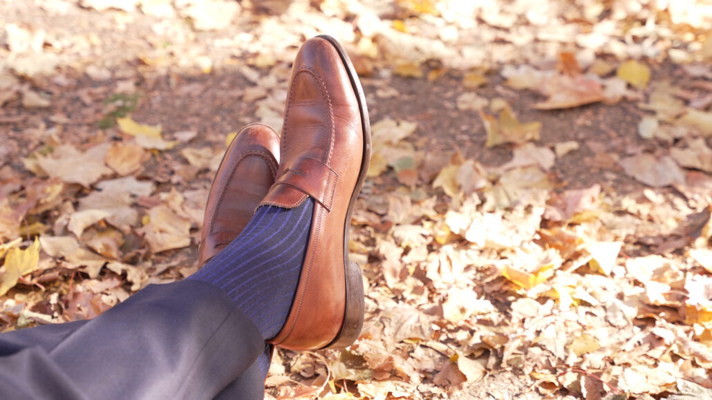 A pair of medium brown penny loafers with Shadow Stripe Ribbed Socks Dark Navy Blue and Royal Blue from Fort Belvedere