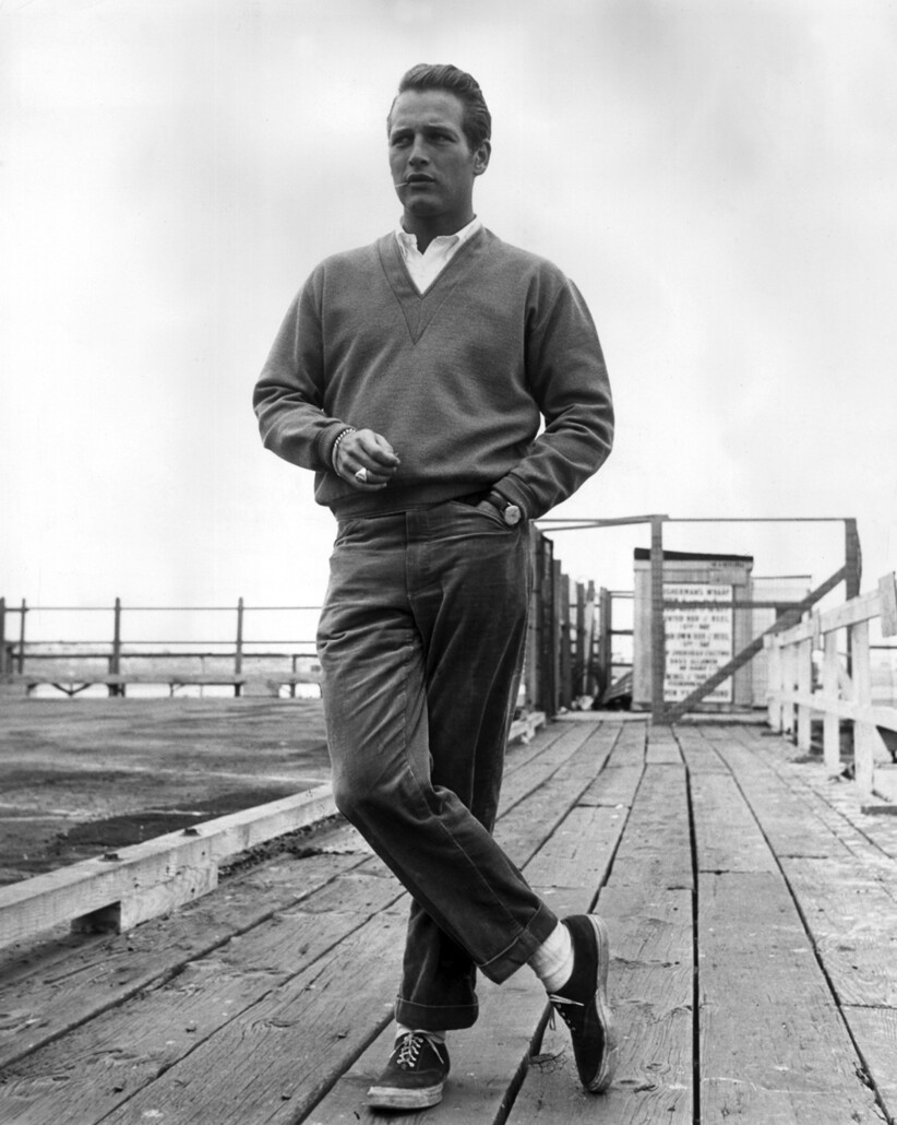 Paul Newman showcases casual style with the use of a v neck sweater
