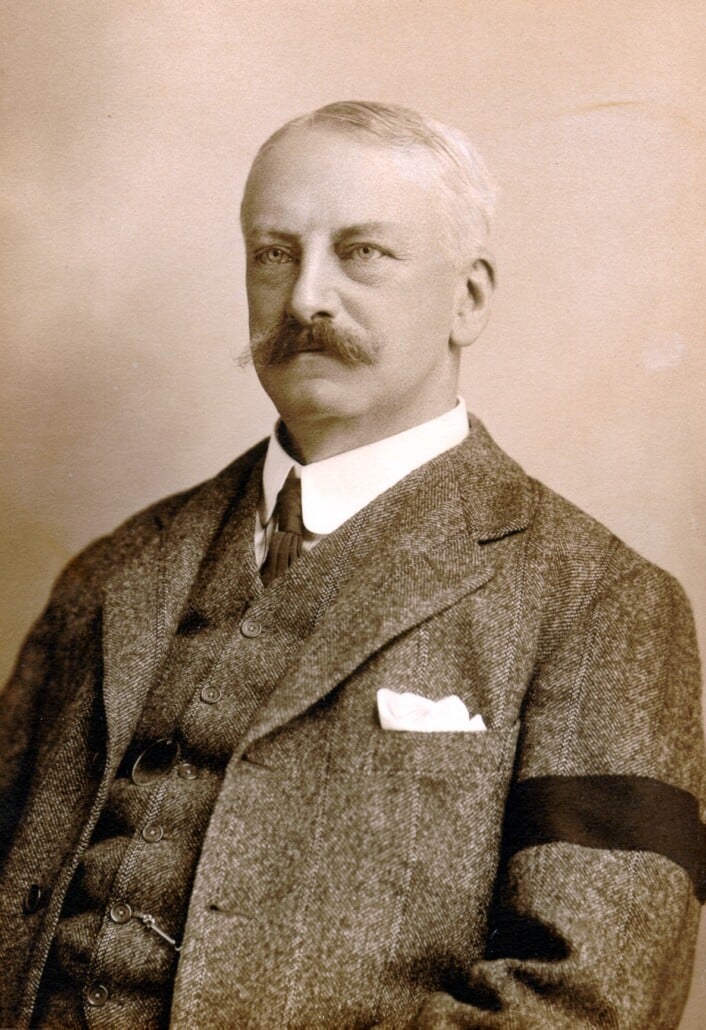 A photograph of a man wearing a black arm band