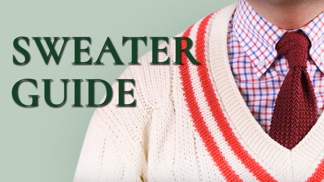 Raphael wears a white tennis sweater with red accents over a blue-and-red microchecked shirt and a red knit tie