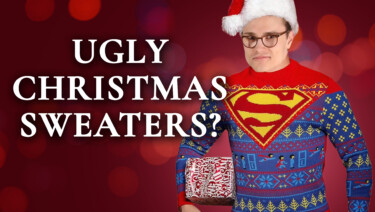 Preston in an ugly, Superman-themed holiday sweater and Santa hat, with a wrapped present under one arm