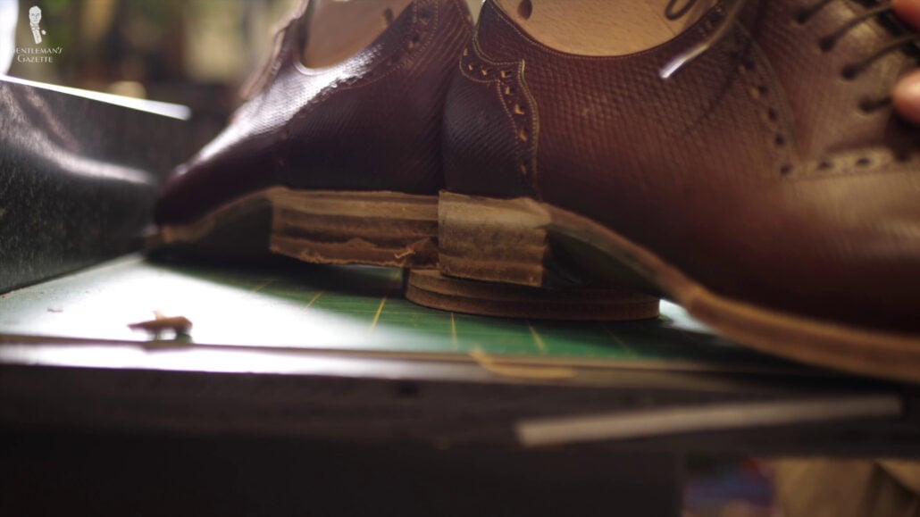 Amara checks the heels from all angles because she wants the shoes to stand in a certain way.