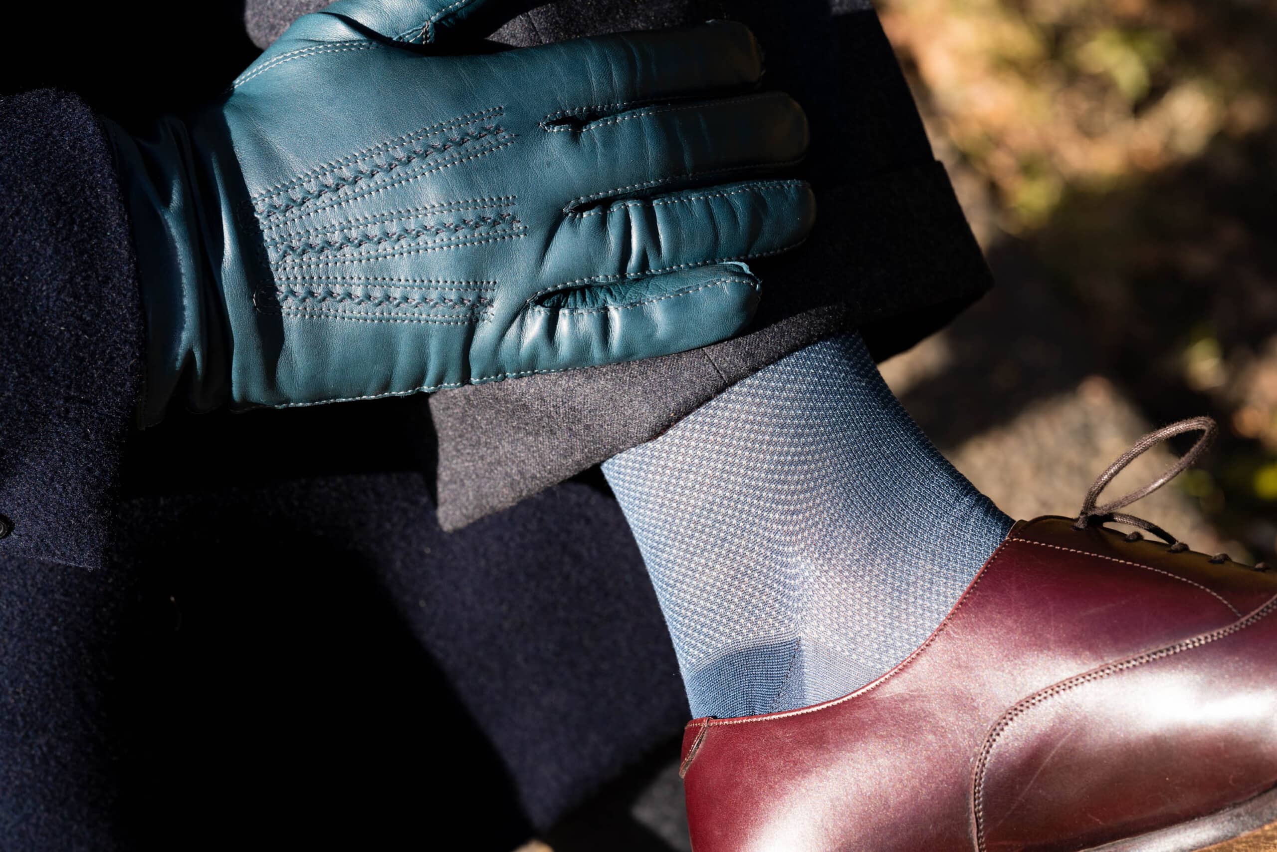 A blue sock worn with oxblood shoes