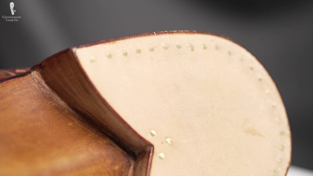 Raphael Had To Return This Pair Of Shoes To Amara To Have A Rubber Cap Added The heel of Raphael's bespoke shoes showing the nail details.