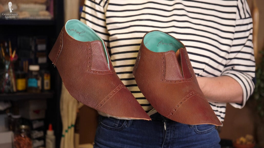 Raphael Wanted To Copy The Design Of The Faux Toe Cap To The Heel To Create A Consistent Unusual Detail Amara holding the bespoke shoes' uppers.
