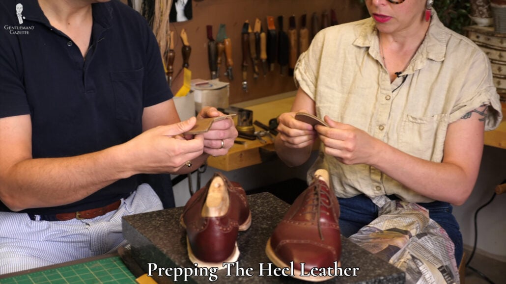 Amara and Raphael inspecting the pre-cut leather that will be used for the bespoke shoes' heel.