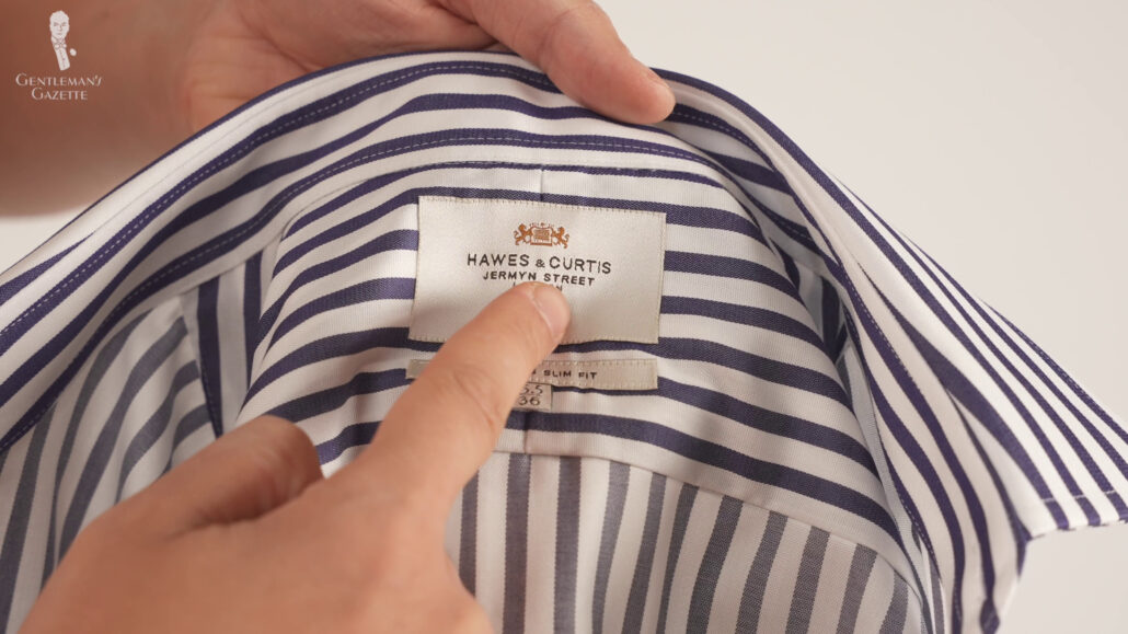 Navy blue striped buttoned shirt that has a stiffer interlining.