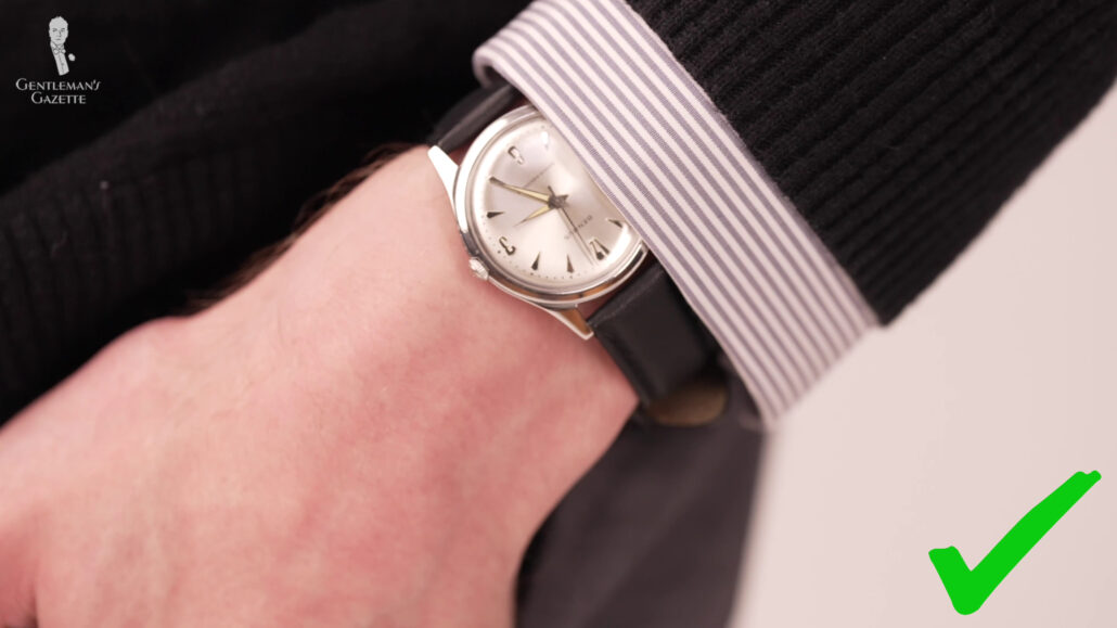 Preston wearing a black and white vintage watch.