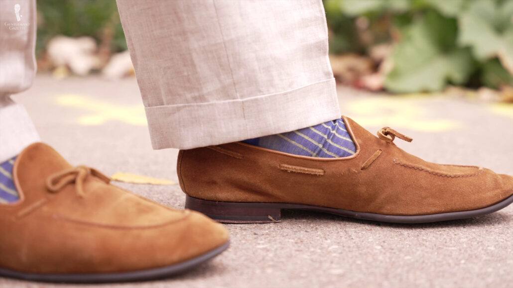 Caramel loafers paired with Bright blue and Yellow socks.
