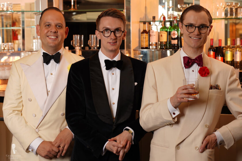 Three men stand at a bar in Black Tie 