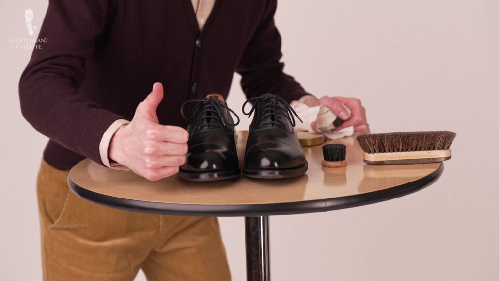 Preston giving a thumbs up with the right tools to use for mirror shining your shoes.