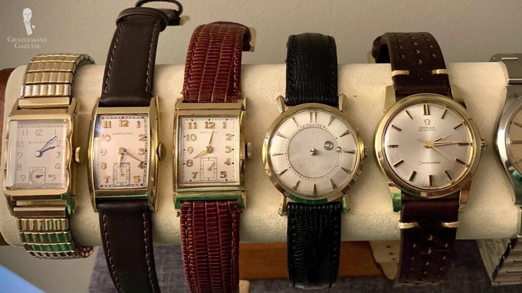 An array of vintage watches neatly placed on a watch rack.
