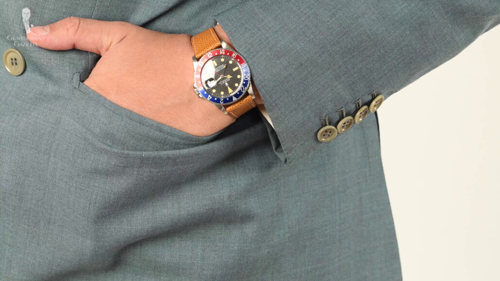 Raphael wearing a Rolex with light brown straps.