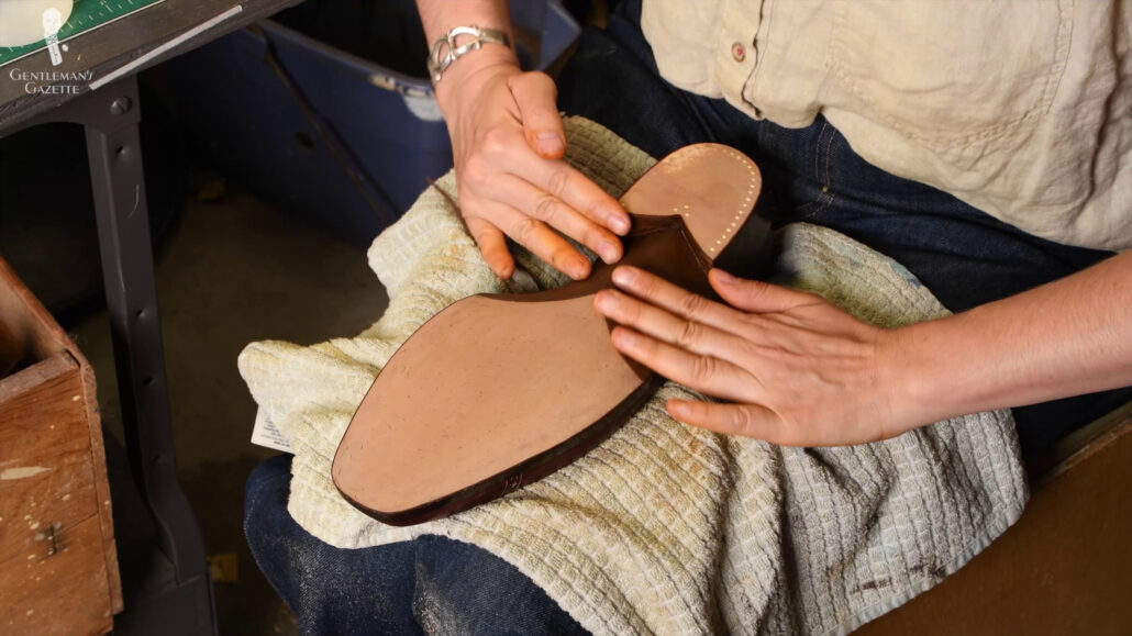 After spraying water, the sole is massaged by hand which helps ensure a smooth and even texture of the leather.