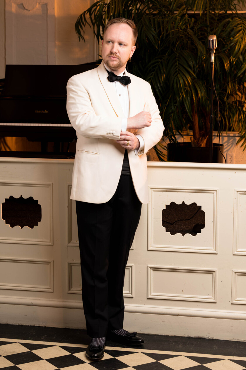 Photo of man wearing an ivory dinner jacket with Black Tie ensemble