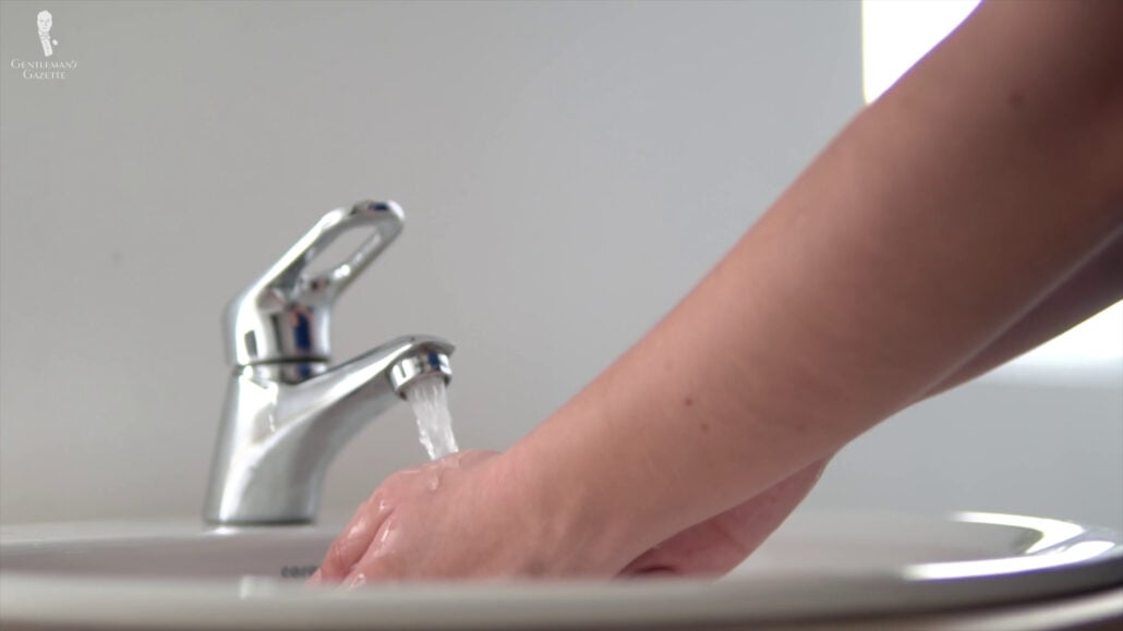 Checking The Water Temperature By Hand. Checking the water temperature by hand.