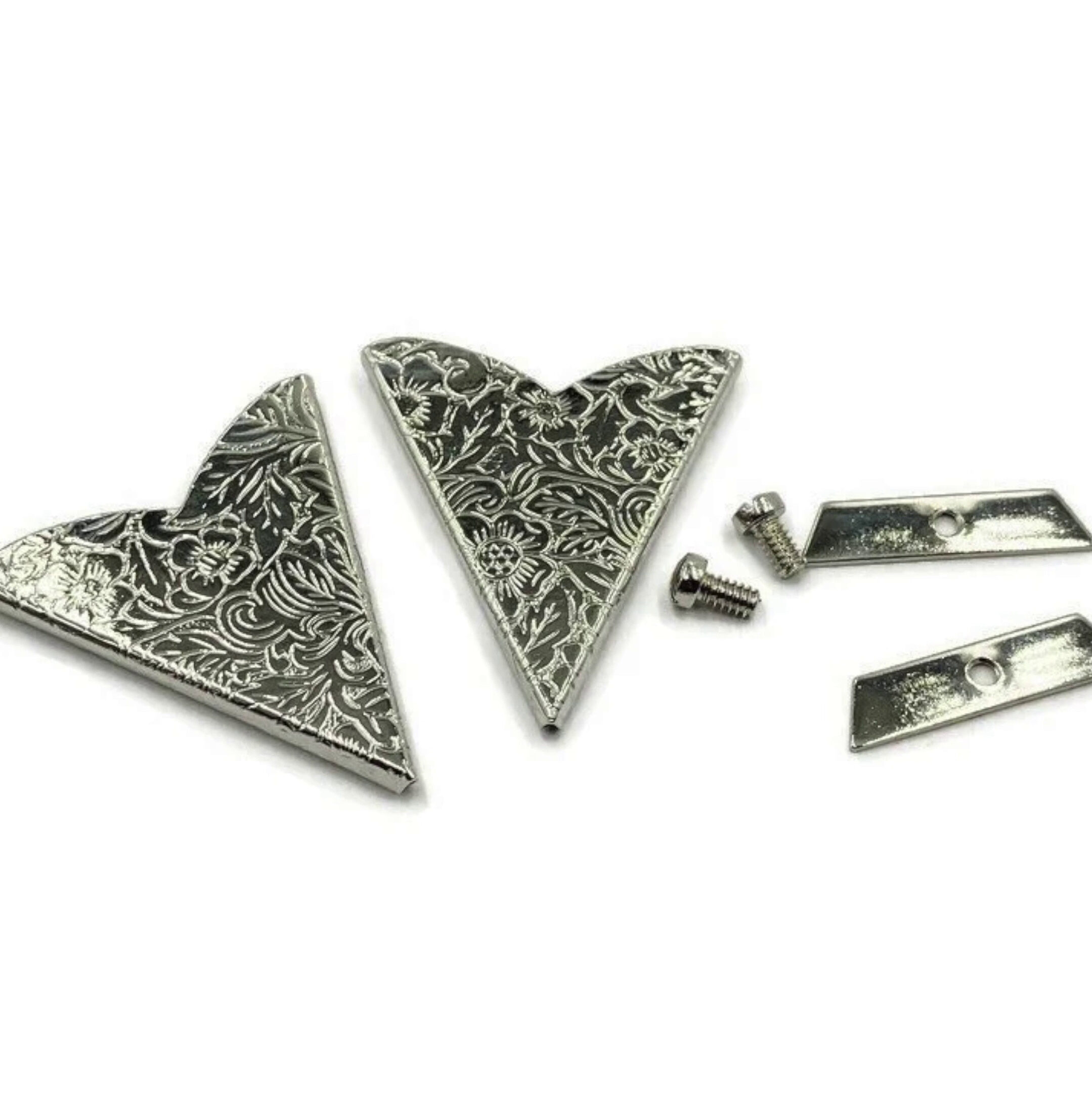 Decorative metal Collar Tips for western and rockabilly shirts made of silver and metal with cowboy motifs, stones, and filigrees.