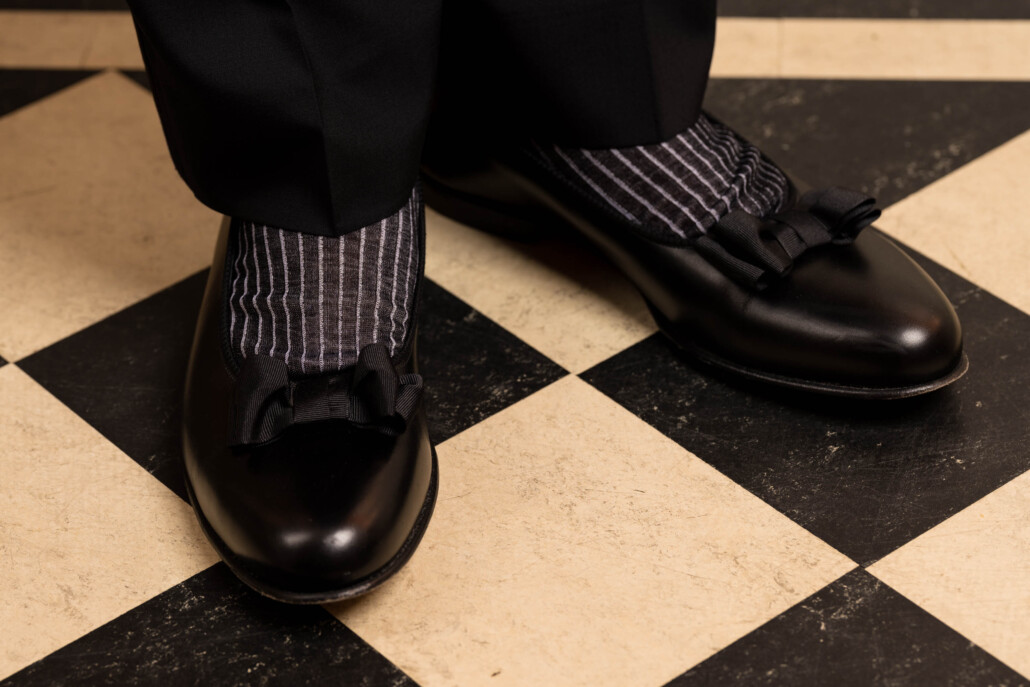 Close up photo of black an d white formal socks worn with opera pumps