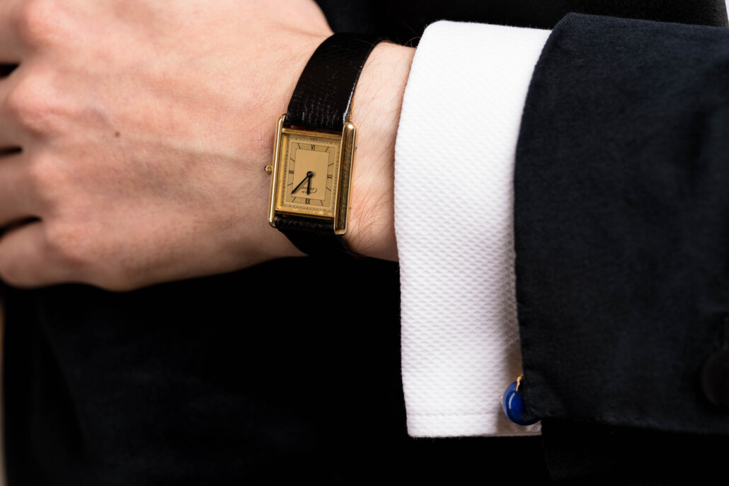 Photo of a cuff in Black Tie ensemble with evening Cartier Tank wristwatch and cufflinks