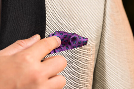 Close up of a purple pocket square in a dinner jacket