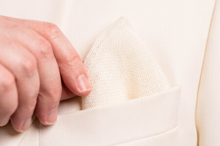 Close up photo of linen pocket square in white dinner jacket pocket