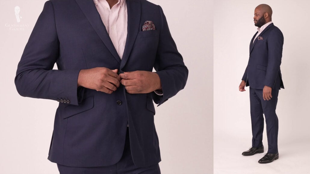 Kyle wearing a sleek navy blue suit style with classic black dress shoes.