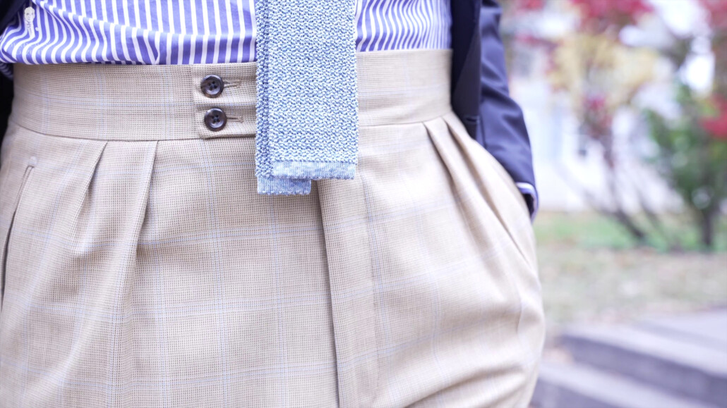 Double button pants with a blue striped shirt and wool neck tie.
